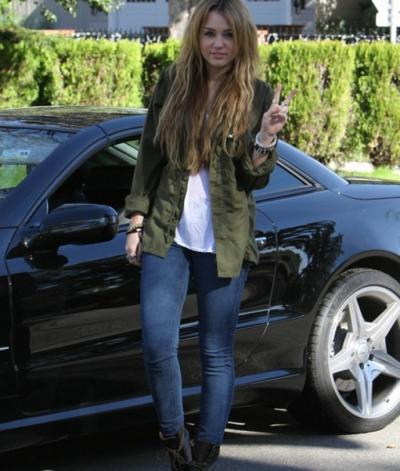 Miley cyrus with her car
